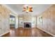 Living room with hardwood floors, fireplace and unique wallpaper at 7754 Westmoreland Dr, Sarasota, FL 34243