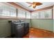 Laundry room with washer, dryer, and wood floors at 7754 Westmoreland Dr, Sarasota, FL 34243