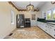 Kitchen boasts stainless steel appliances and herringbone tile floor at 7754 Westmoreland Dr, Sarasota, FL 34243