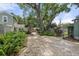 Landscaped backyard with brick pavers and lush greenery at 7754 Westmoreland Dr, Sarasota, FL 34243