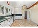Classic kitchen with white cabinets, green countertops, and a brick-patterned floor at 7754 Westmoreland Dr, Sarasota, FL 34243