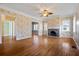 Spacious living room with hardwood floors, fireplace and unique wallpaper at 7754 Westmoreland Dr, Sarasota, FL 34243