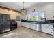 Kitchen with stainless steel appliances, herringbone tile floor, and decorative border at 7754 Westmoreland Dr, Sarasota, FL 34243