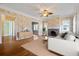 Living room featuring hardwood floors, fireplace, and large windows at 7754 Westmoreland Dr, Sarasota, FL 34243