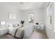 Bright bedroom with a queen bed, desk, and large windows at 7754 Westmoreland Dr, Sarasota, FL 34243