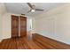 Bedroom with hardwood floors, double doors, and access to closets at 7754 Westmoreland Dr, Sarasota, FL 34243