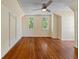 Spacious bedroom with hardwood floors, two windows, and ceiling fan at 7754 Westmoreland Dr, Sarasota, FL 34243