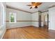 Hardwood floor bedroom with ceiling fan and access to exterior at 7754 Westmoreland Dr, Sarasota, FL 34243