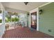 Inviting front porch with brick flooring and white railings at 7754 Westmoreland Dr, Sarasota, FL 34243
