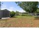 Large backyard with shed and mature trees at 7754 Westmoreland Dr, Sarasota, FL 34243