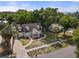 House exterior with mature landscaping and large trees at 7754 Westmoreland Dr, Sarasota, FL 34243