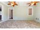 Bright sunroom features tile flooring and ceiling fans at 7754 Westmoreland Dr, Sarasota, FL 34243