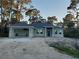 New construction home featuring a blue front door, gray exterior and attached two-car garage at 13126 Marathon Blvd, Port Charlotte, FL 33981