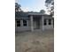 New construction single Gathering home with a modern design, grey stucco, and a covered front porch at 13126 Marathon Blvd, Port Charlotte, FL 33981