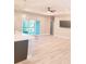 Open living room featuring wood floors, modern lighting, a kitchen island and sliding glass doors to the patio at 13126 Marathon Blvd, Port Charlotte, FL 33981