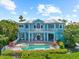 Luxurious backyard with a private pool, spa, and balconies offering stunning views of the lush landscape at 757 Hideaway Bay Dr, Longboat Key, FL 34228