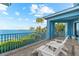Relax on the balcony with tranquil water views and comfortable Adirondack chairs at 757 Hideaway Bay Dr, Longboat Key, FL 34228