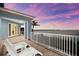 Outdoor balcony features tile flooring, white railing, and scenic water view at sunset at 757 Hideaway Bay Dr, Longboat Key, FL 34228