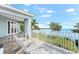 Relaxing balcony overlooking the water with tiled floor and white chairs at 757 Hideaway Bay Dr, Longboat Key, FL 34228