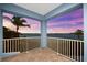 This outdoor balcony offers tile flooring, white railing, and scenic water views at 757 Hideaway Bay Dr, Longboat Key, FL 34228
