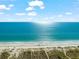 A bright, sunny day over the ocean meets a pristine sandy beach with sun glittering on the water at 757 Hideaway Bay Dr, Longboat Key, FL 34228