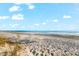 Beautiful beach day with lounge chairs placed in the soft white sand near a clear blue ocean at 757 Hideaway Bay Dr, Longboat Key, FL 34228