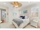 Bright and airy bedroom with white furniture, ceiling fan, and natural light at 757 Hideaway Bay Dr, Longboat Key, FL 34228