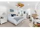 Inviting bedroom featuring a decorative ceiling fan, stylish furnishings, and ample natural light at 757 Hideaway Bay Dr, Longboat Key, FL 34228
