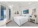 Bright bedroom features crisp white bedding, shuttered windows, and stylish furnishings at 757 Hideaway Bay Dr, Longboat Key, FL 34228