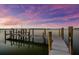 Waterfront view with wooden boat dock at sunset at 757 Hideaway Bay Dr, Longboat Key, FL 34228