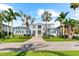 Beautiful two-story home with a manicured lawn, charming facade, and a welcoming entrance way at 757 Hideaway Bay Dr, Longboat Key, FL 34228