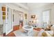 Bright living room featuring wood floors, white trim, and glass doors leading to another room at 757 Hideaway Bay Dr, Longboat Key, FL 34228