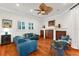 Open living room showcasing hardwood floors, white walls, a ceiling fan, and comfortable furniture at 757 Hideaway Bay Dr, Longboat Key, FL 34228