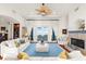 Bright living room boasts water views, a fireplace, neutral furniture, and unique ceiling fan for relaxation and entertainment at 757 Hideaway Bay Dr, Longboat Key, FL 34228