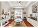 Cozy living room with built-in cabinets, a light-colored area rug, hardwood floors, and bright natural light at 757 Hideaway Bay Dr, Longboat Key, FL 34228