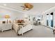 Bright main bedroom with ceiling fan, bay window, and french doors to private balcony at 757 Hideaway Bay Dr, Longboat Key, FL 34228