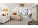 Spacious main bedroom with sitting area, ceiling fan, and french doors to private balcony at 757 Hideaway Bay Dr, Longboat Key, FL 34228