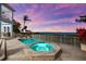 Outdoor pool and hot tub area with waterfront views in a landscaped backyard at 757 Hideaway Bay Dr, Longboat Key, FL 34228