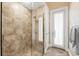 Modern shower offers seamless glass enclosure and travertine surround at 757 Hideaway Bay Dr, Longboat Key, FL 34228