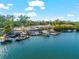 View of a waterfront boat repair and docking business with boats and lifts on a sunny day at 757 Hideaway Bay Dr, Longboat Key, FL 34228