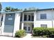 Building exterior featuring a two-story design, light-colored walls, and lush landscaping at 4601 46Th Street W Ct # 202B, Bradenton, FL 34210