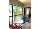 Bright screened balcony showcasing a small table and chairs, perfect for enjoying the outdoors at 4601 46Th Street W Ct # 202B, Bradenton, FL 34210