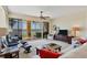 Bright living room with a view of the lake and access to a screened balcony at 6360 Watercrest Way # 301, Bradenton, FL 34202