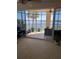 Living room with view of a screened balcony and lake at 6360 Watercrest Way # 301, Bradenton, FL 34202