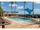 Resort-style pool with lounge chairs, pergola, and shade structure at 6360 Watercrest Way # 301, Bradenton, FL 34202