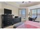 Main bedroom with large TV, dresser, and water views at 6360 Watercrest Way # 301, Bradenton, FL 34202