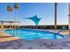 Resort-style pool with comfortable lounge chairs and shade structure at 6360 Watercrest Way # 301, Bradenton, FL 34202