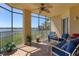 Spacious screened balcony with lake view and outdoor seating at 6360 Watercrest Way # 301, Bradenton, FL 34202