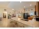 Open kitchen with island, stainless steel appliances and breakfast bar at 8499 Topeka Cir, Port Charlotte, FL 33981