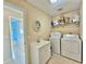 Laundry room with washer, dryer, and utility sink at 9390 Gulfstream Blvd, Englewood, FL 34224